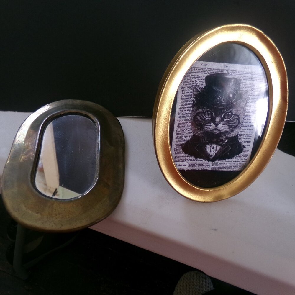 2 antique metal picture frames.